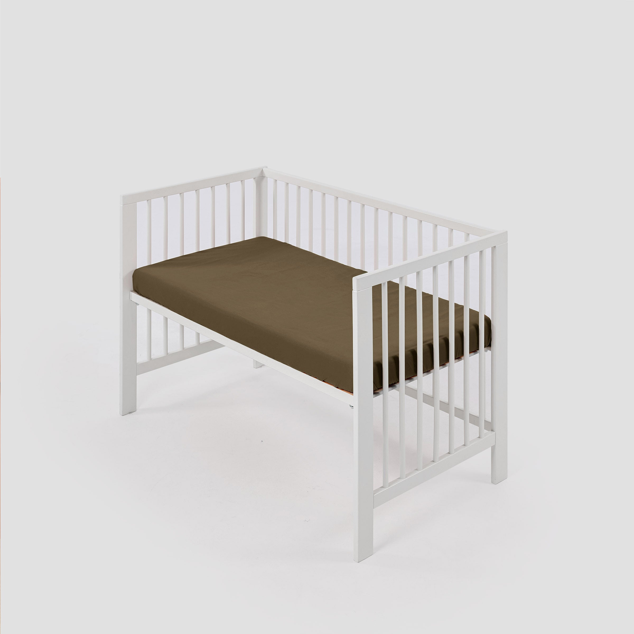 organic-classic-baby-cot-fitted-sheet-in-moss-colour-inside-a-cot-by-sojao