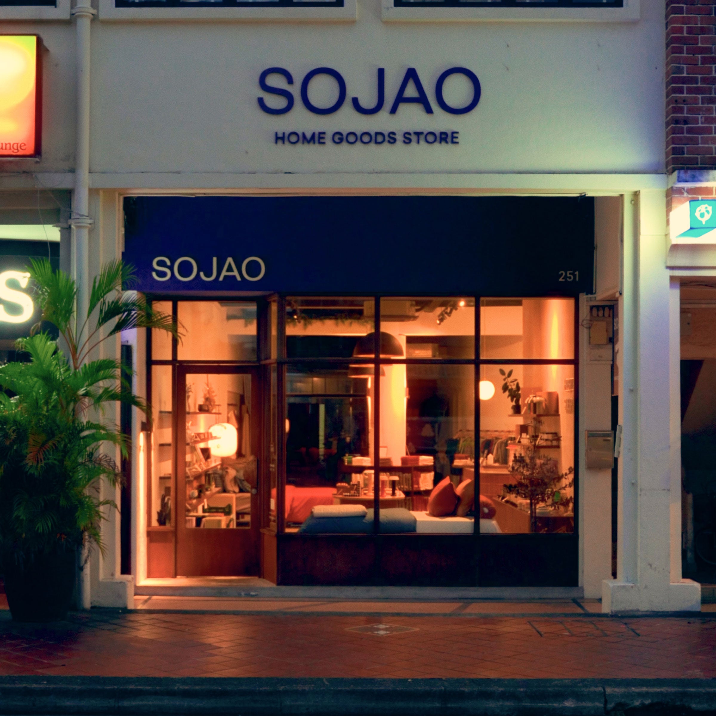 SOJAO Home Goods Store front at night with illuminated interior