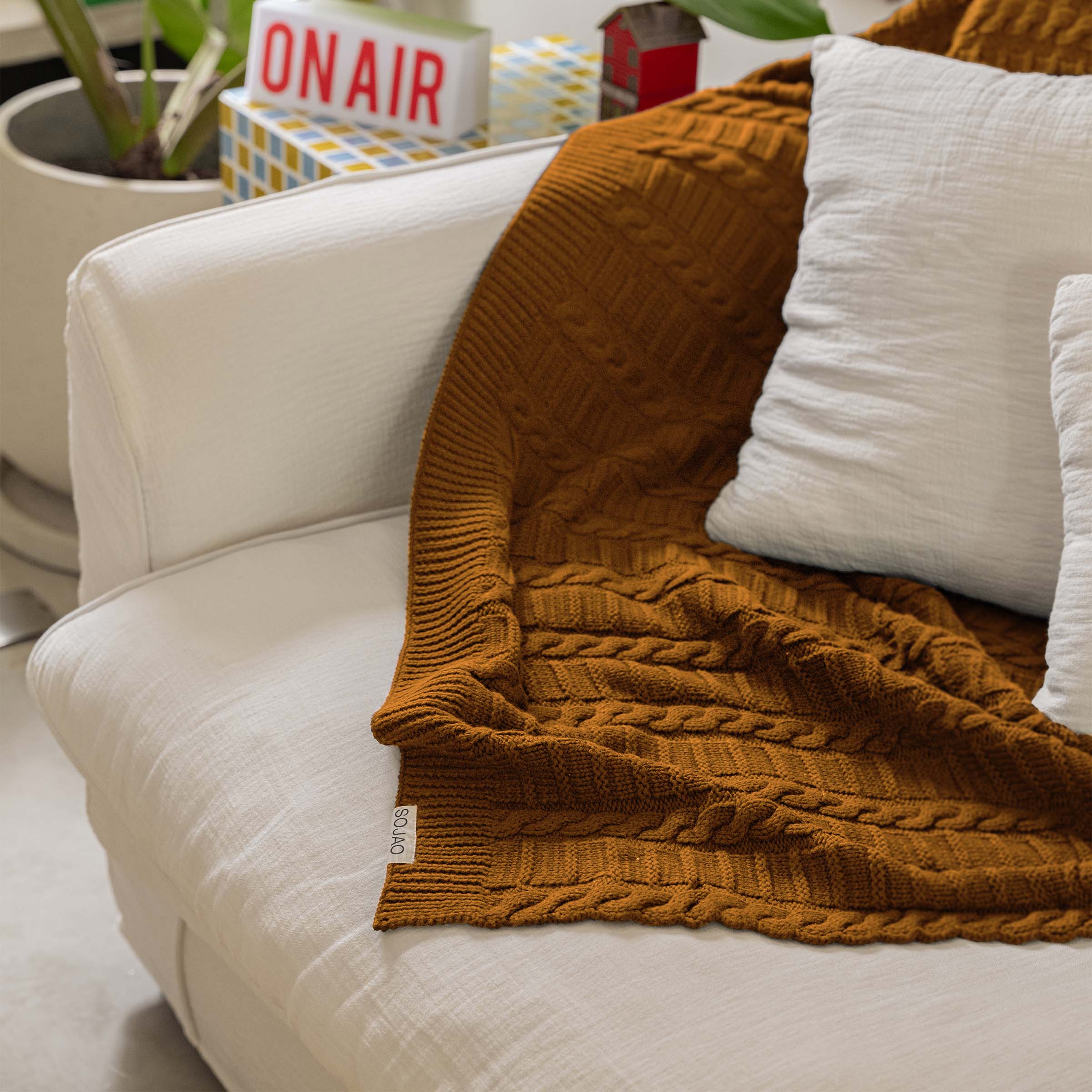 organic-cotton-cable-knit-throw-in-mustard-colour-on-the-sofa-by-sojao