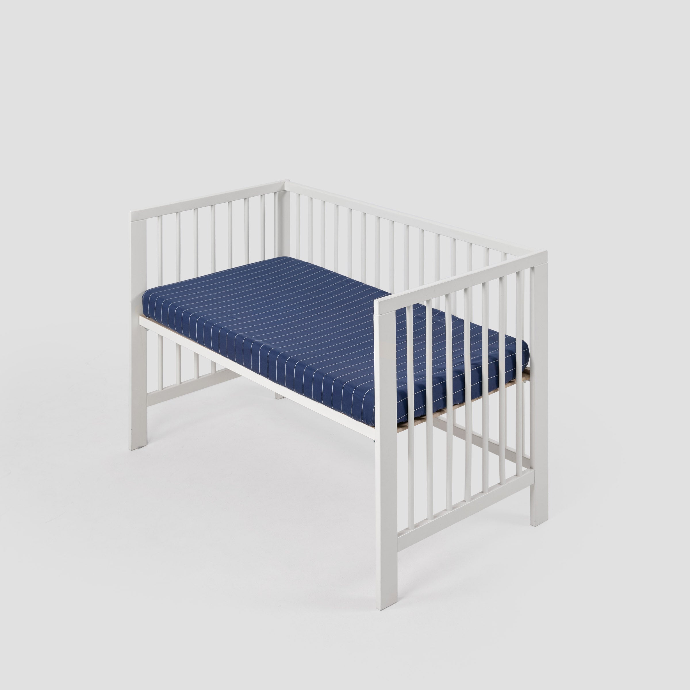 organic-classic-baby-cot-fitted-sheet-in-navy-pinstripes-colour-inside-a-cot-by-sojao