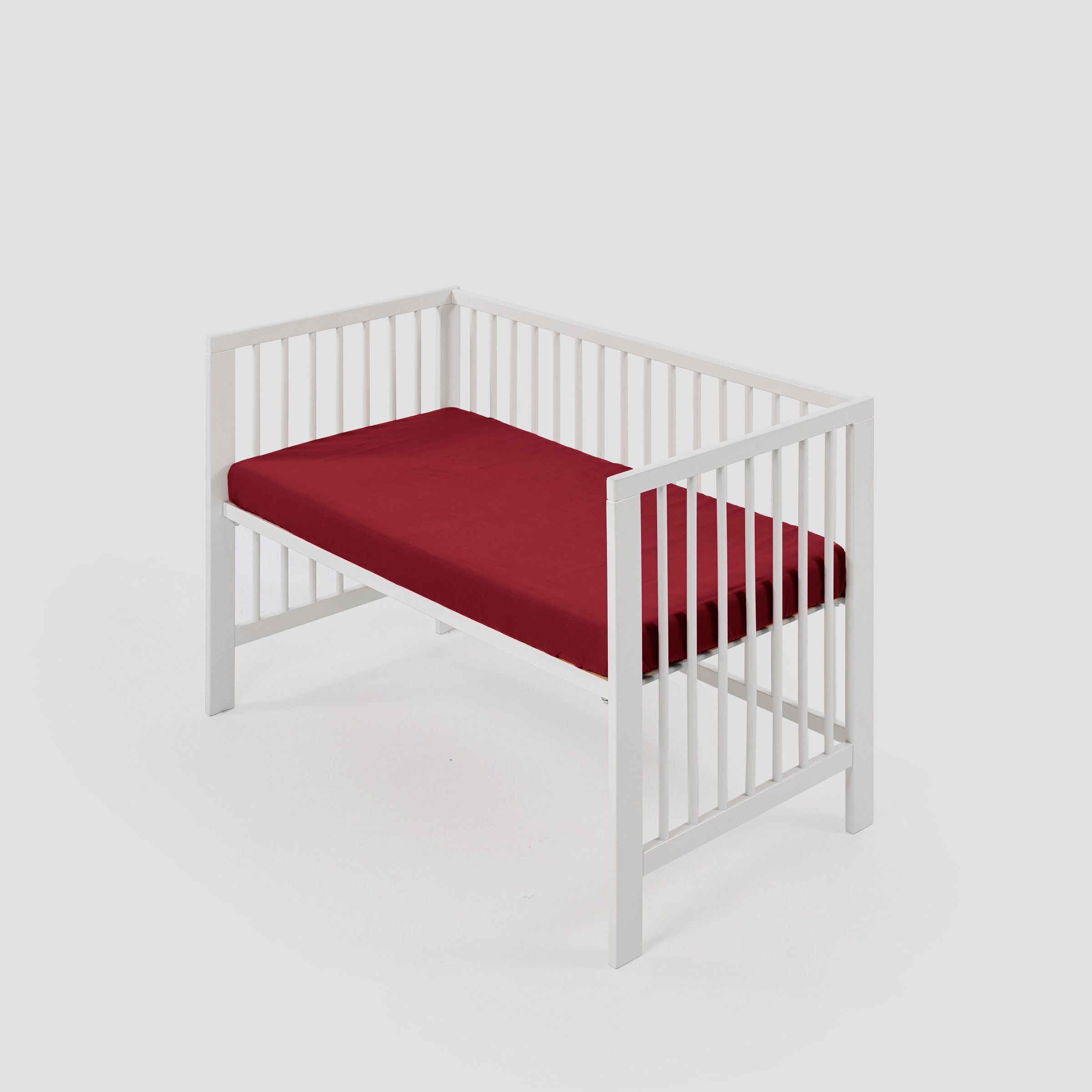 organic-classic-baby-cot-fitted-sheet-in-wine-colour-inside-a-cot-by-sojao