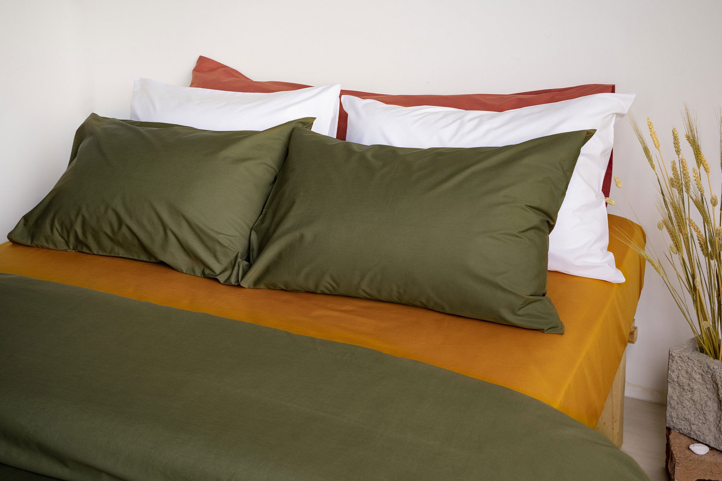 crisp-olive-duvet-cover-pillowcase-pair-mustard-fitted-sheet-white-pillowcase-pair-clay-body-pillow-side-view-by-sojao.jpg