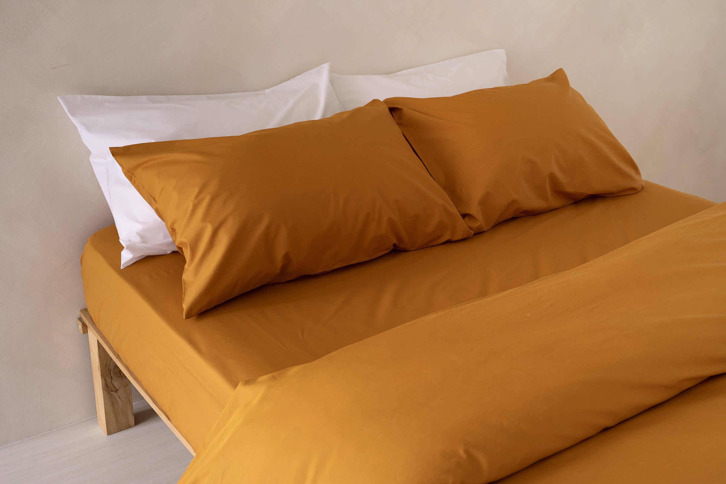 crisp-mustard-fitted-sheet-duvet-cover-pillowcase-pair-white-pillowcase-pair-side-view-by-sojao.jpg