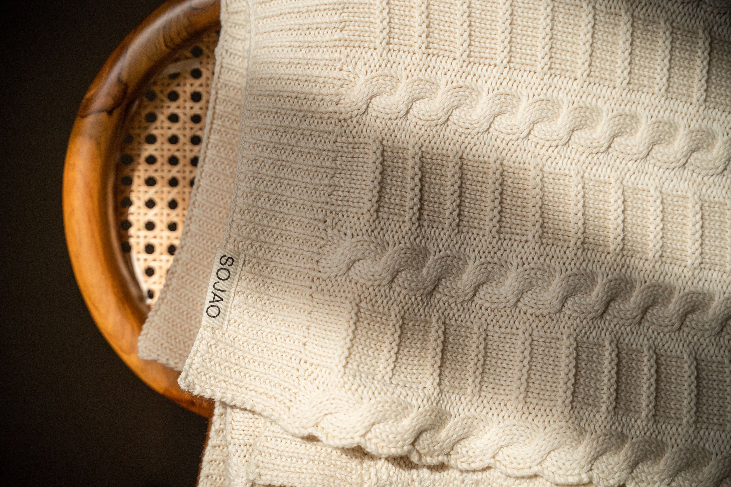 ivory-cable-knit-throw-mid-shot-by-sojao