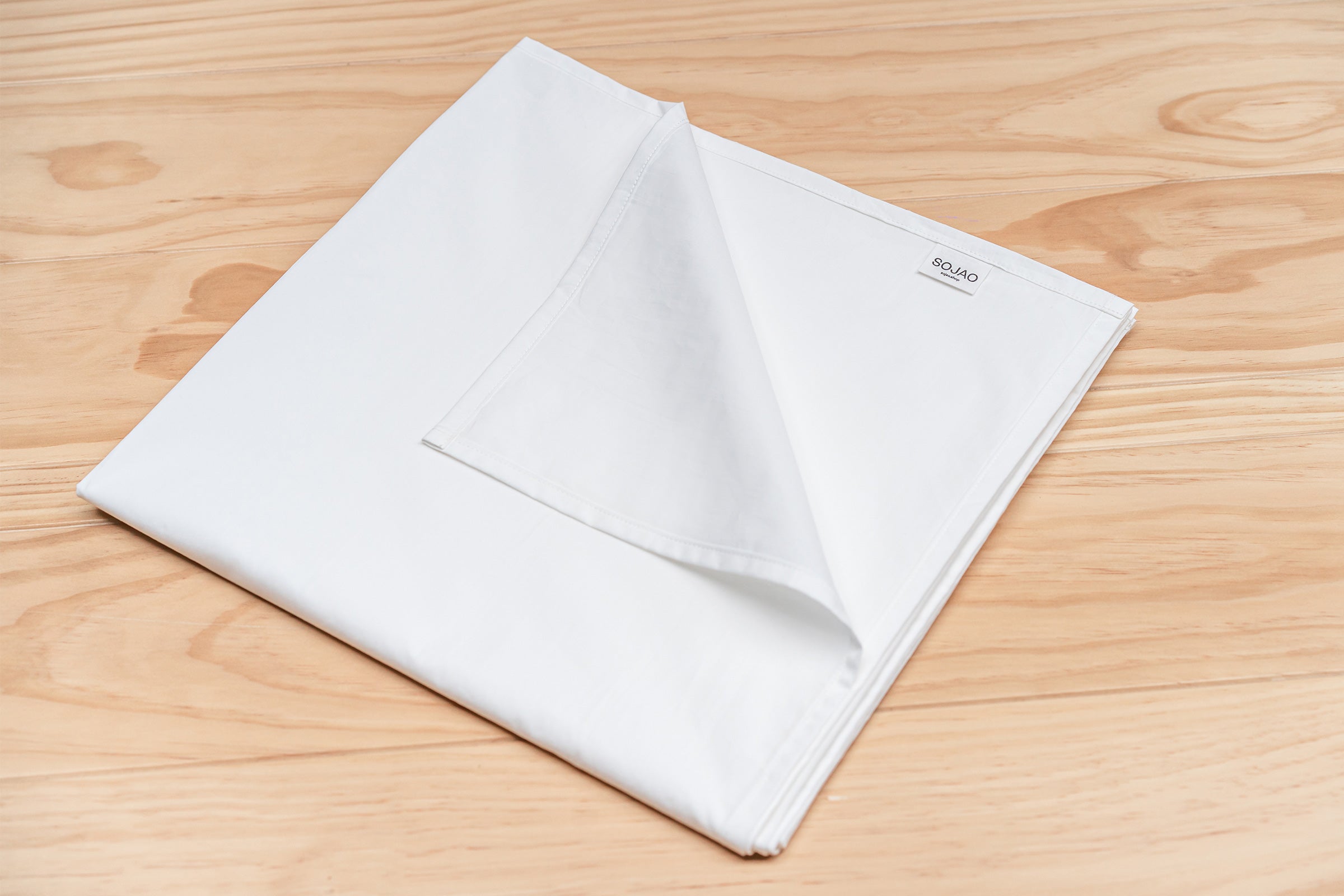 crisp-white-organic-cotton-table-cloth-folded-by-sojao.jpg